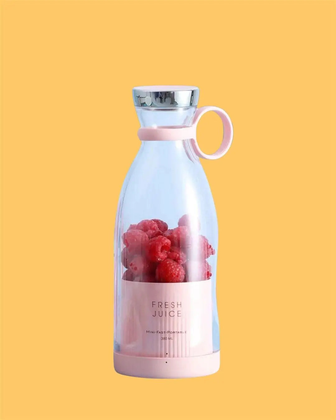 Pink portable juicer with fruit on a yellow background